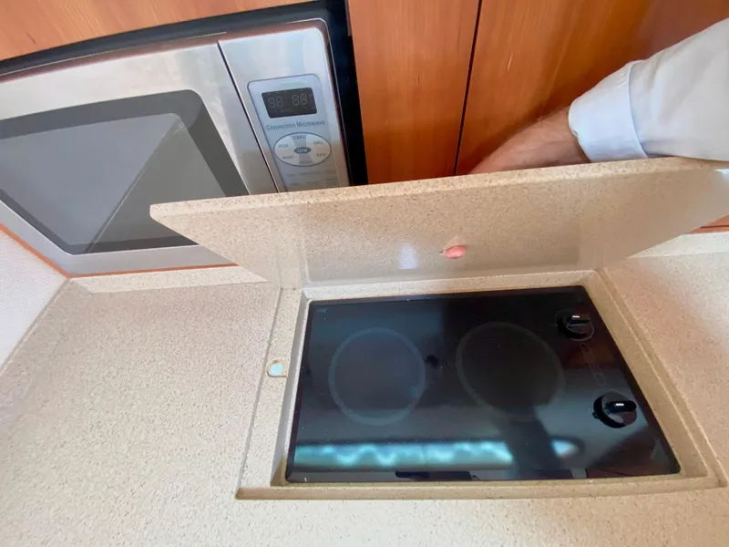Slide: The Image of 2007 Chris-Craft Roamer 40 kitchen with stove and microwave. - 38