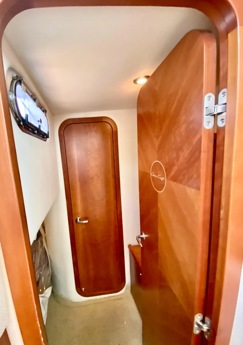 Slide: The Image of 2007 Chris-Craft Roamer 40 interior with wooden doors and porthole window. - 43