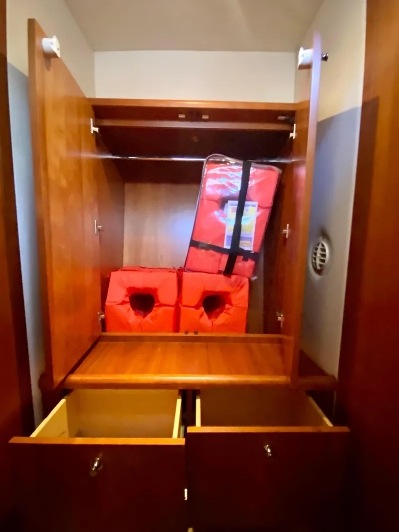 Slide: The Image of Wooden storage cabinet with life jackets on a 2007 Chris-Craft Roamer 40 boat. - 47
