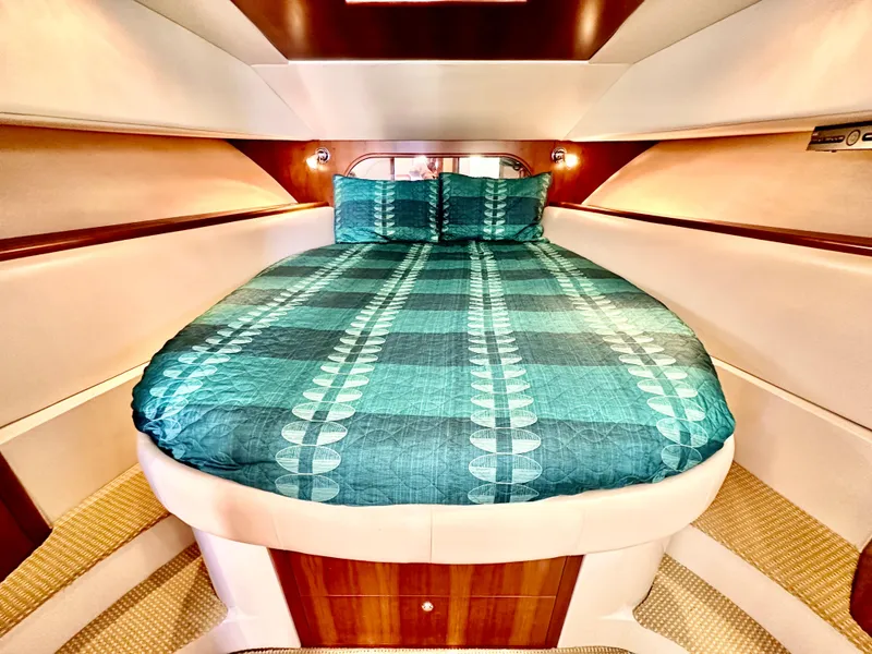 Slide: The Image of Luxurious cabin interior of 2007 Chris-Craft Roamer 40 yacht with teal bedding. - 53