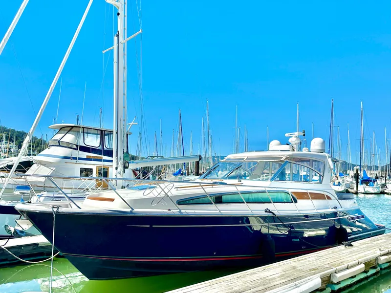 Slide: The Image of 2007 Chris-Craft Roamer 40 yacht docked in a marina under clear blue skies. - 8