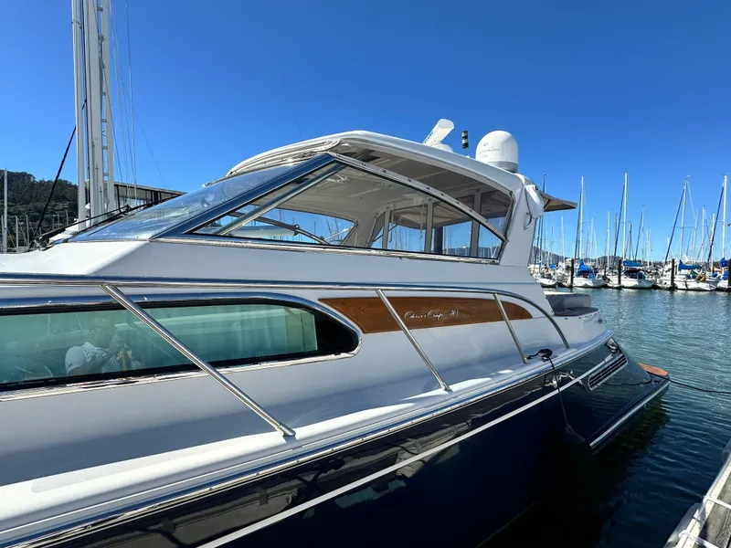 Slide: The Image of 2007 Chris-Craft Roamer 40 yacht docked in a marina under clear blue skies. - 9