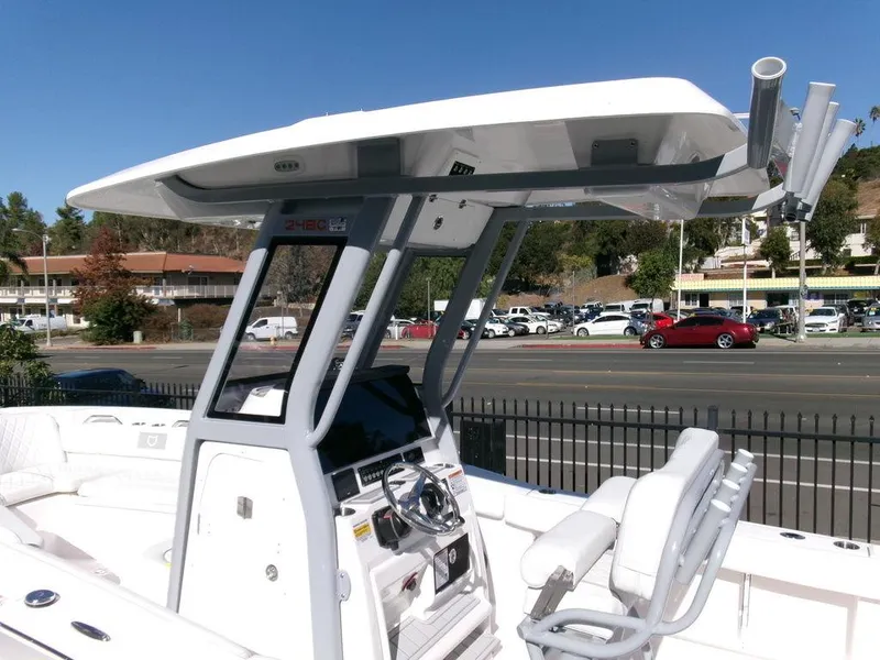Slide: The Image of 2025 Sea Fox 248 Commander boat with T-top and helm station, parked near a road. - 15