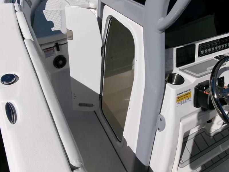 Slide: The Image of 2025 Sea Fox 248 Commander boat interior with open cabin door and steering console. - 18