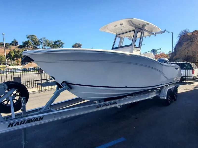 Slide: The Image of 2025 Sea Fox 248 Commander boat on Karavan trailer, parked outdoors. - 2