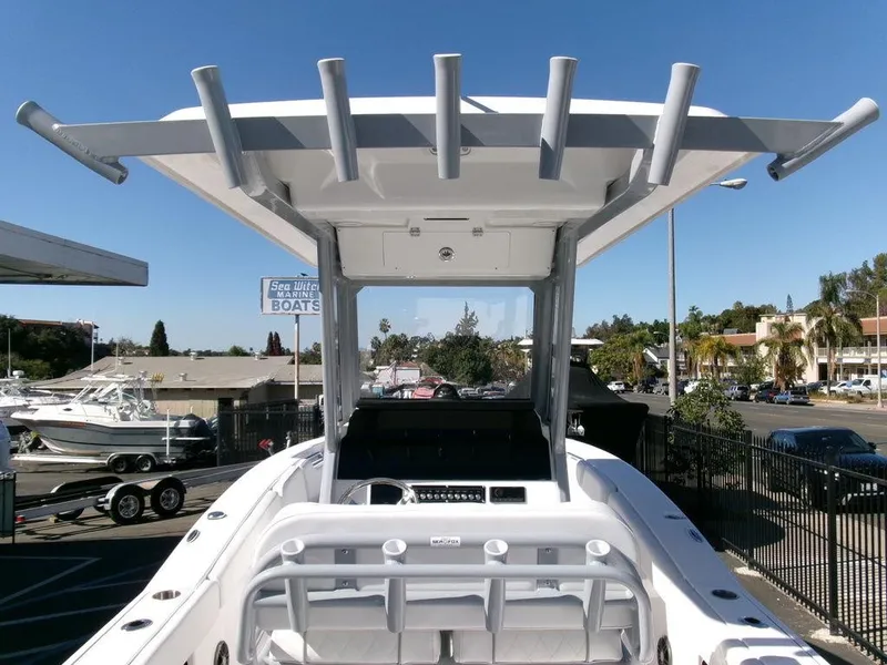 Slide: The Image of 2025 Sea Fox 248 Commander boat with T-top and rod holders, displayed outdoors. - 24