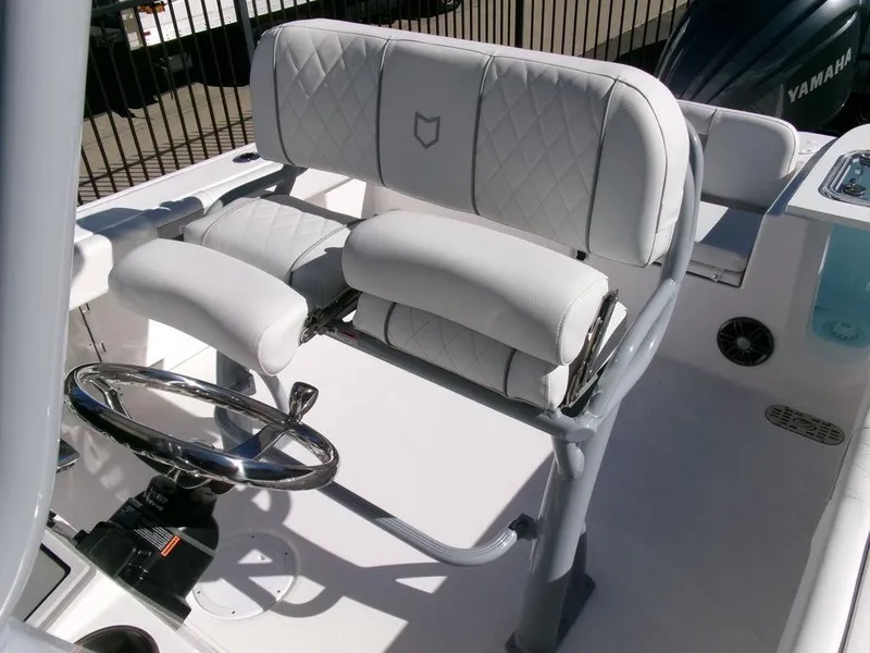 Slide: The Image of 2025 Sea Fox 248 Commander boat helm with cushioned seating and steering wheel. - 25