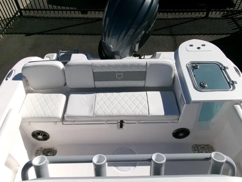Slide: The Image of 2025 Sea Fox 248 Commander boat interior with cushioned seating and motor. - 27