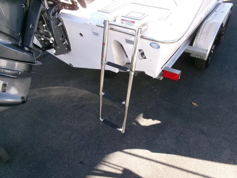 Slide: The Image of 2025 Sea Fox 248 Commander boat with a rear boarding ladder and trailer. - 35