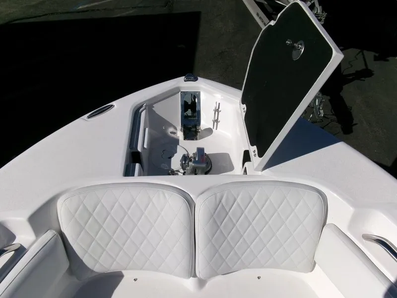 Slide: The Image of 2025 Sea Fox 248 Commander boat bow with open storage compartment and cushioned seating. - 6