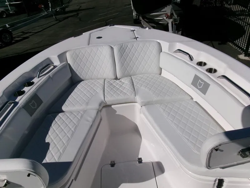 Slide: The Image of 2025 Sea Fox 248 Commander boat with white cushioned seating and cup holders. - 8