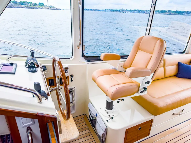 Slide: The Image of Interior of 2012 MJM 40z Downeast yacht with leather seating and wooden steering wheel. - 17