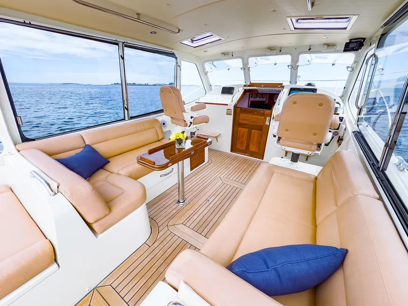Slide: The Image of 2012 MJM 40z Downeast yacht interior with beige seating and ocean view. - 20