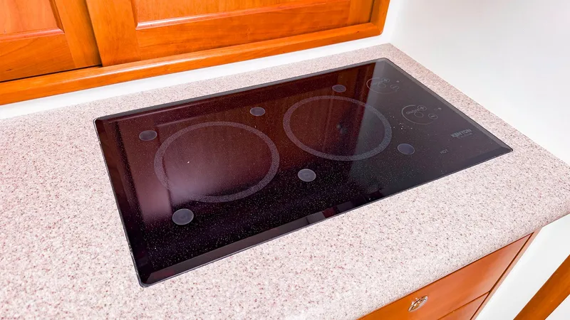 Slide: The Image of Glass cooktop on MJM 40z Downeast 2012 yacht, set in a speckled countertop. - 27