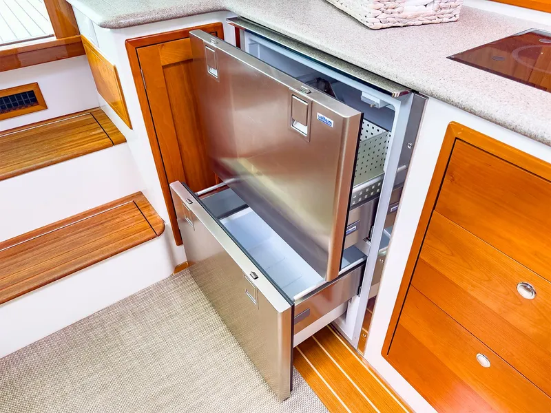 Slide: The Image of 2012 MJM 40z Downeast yacht interior with open stainless steel refrigerator drawers. - 28