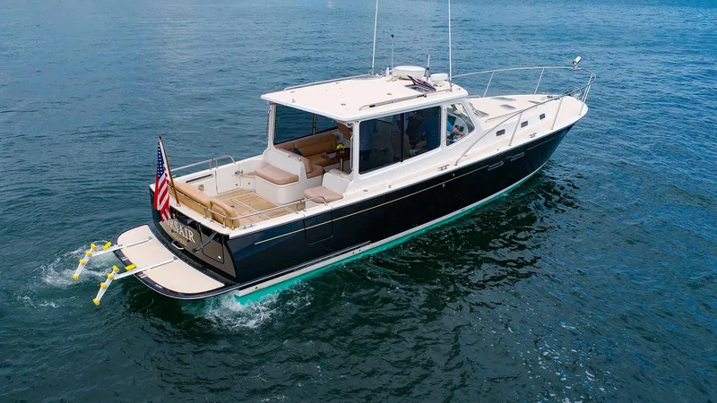 Slide: The Image of 2012 MJM 40z Downeast yacht cruising on open water, rear view. - 3