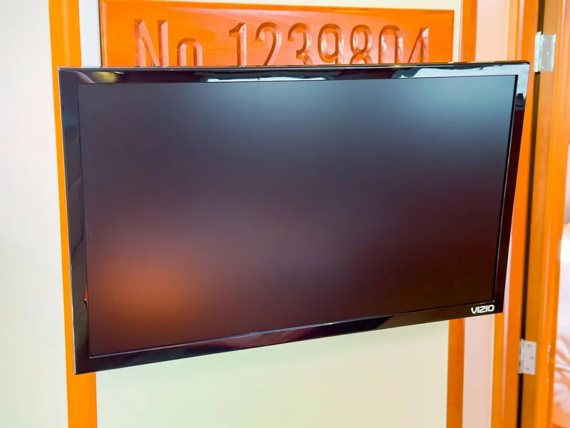 Slide: The Image of Vizio TV mounted on orange wall inside 2012 MJM 40z Downeast boat. - 31