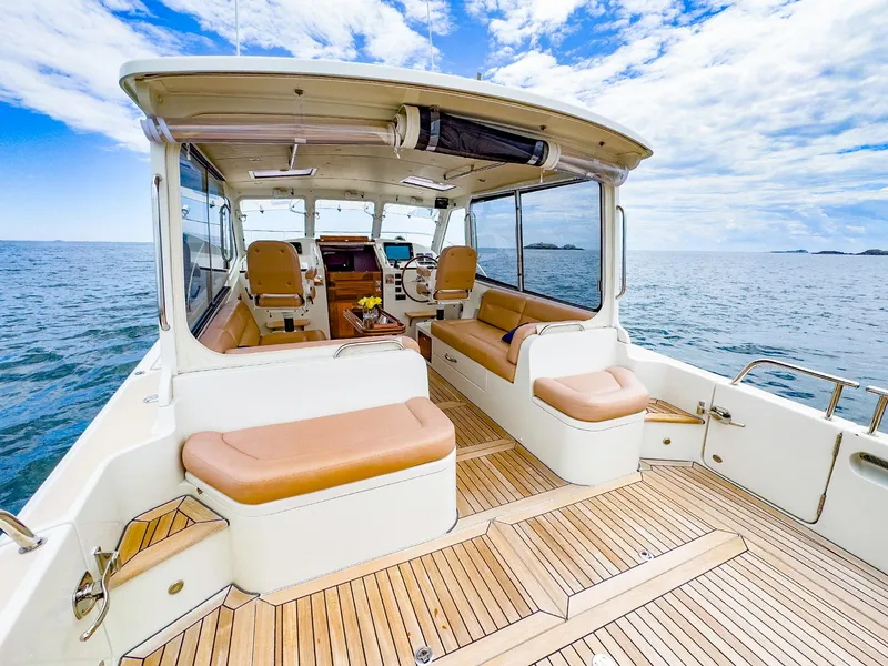 Slide: The Image of 2012 MJM 40z Downeast yacht with spacious deck and luxurious seating on open water. - 6