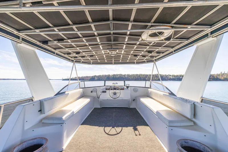 Slide: The Image of 1998 Stardust Cruisers Custom Luxury Houseboat interior with spacious seating and panoramic lake view. - 17