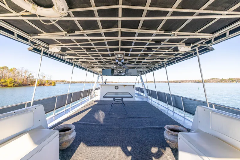 Slide: The Image of 1998 Stardust Cruisers Custom Luxury Houseboat interior with spacious deck and lake view. - 18