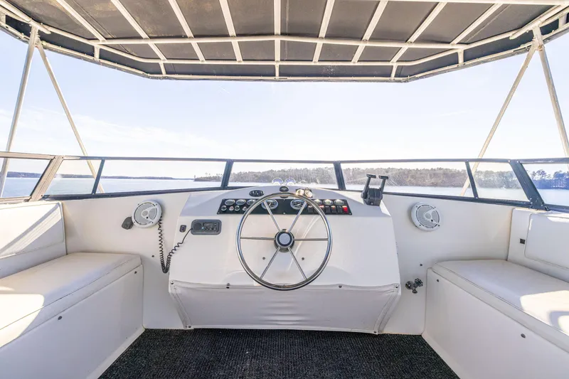 Slide: The Image of 1998 Stardust Cruisers Custom Luxury Houseboat helm with panoramic views and modern controls. - 19