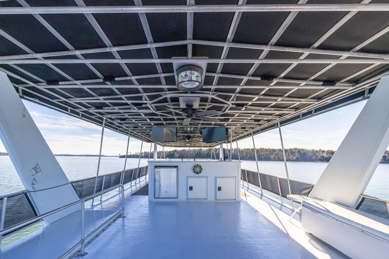 Slide: The Image of 1998 Stardust Cruisers Custom Luxury Houseboat deck with spacious seating and scenic water views. - 21