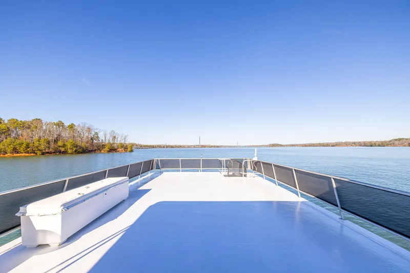Slide: The Image of Rooftop deck of 1998 Stardust Cruisers Custom Luxury Houseboat on a serene lake. - 24