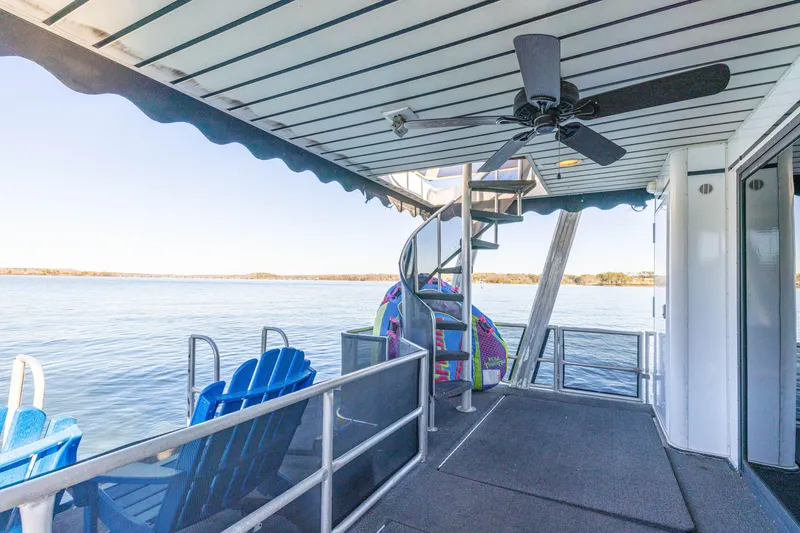Slide: The Image of 1998 Stardust Cruisers Custom Luxury Houseboat deck with spiral staircase and lake view. - 26