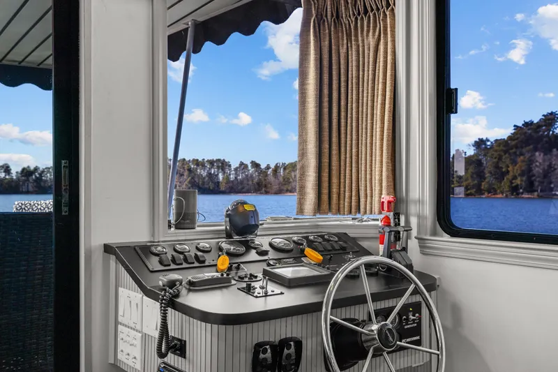 Slide: The Image of 1998 Stardust Cruisers Custom Luxury Houseboat helm with scenic lake view. - 29