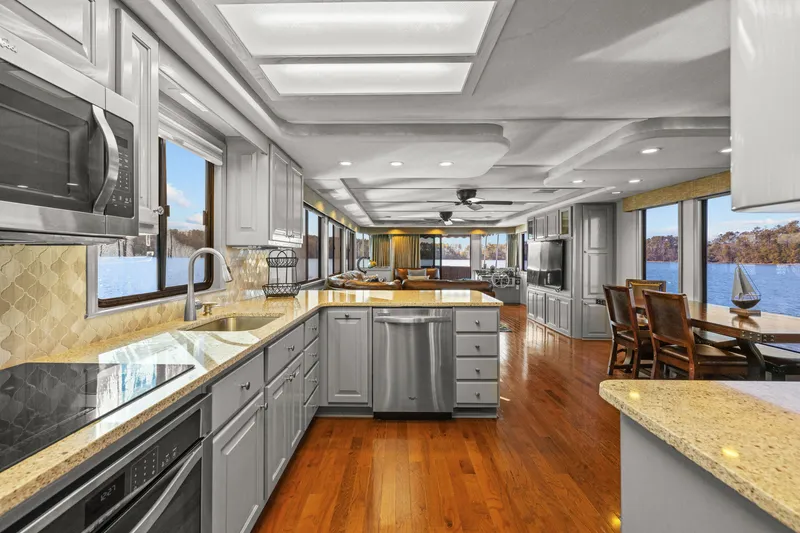 Slide: The Image of Luxurious kitchen interior of 1998 Stardust Cruisers houseboat with modern appliances and scenic water views. - 34