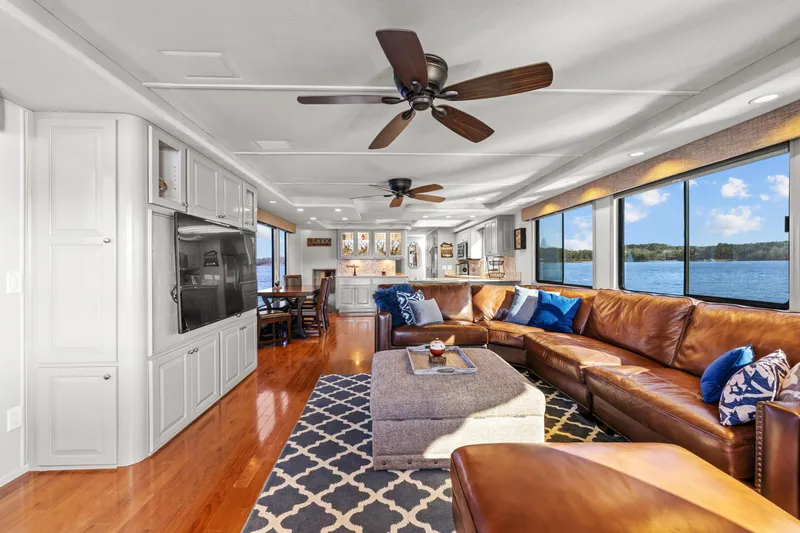 Slide: The Image of Luxurious 1998 Stardust Cruisers houseboat interior with leather seating, large windows, and modern amenities. - 44