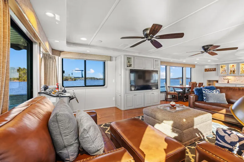 Slide: The Image of Luxurious 1998 Stardust Cruisers houseboat interior with leather seating, large windows, and modern amenities. - 47
