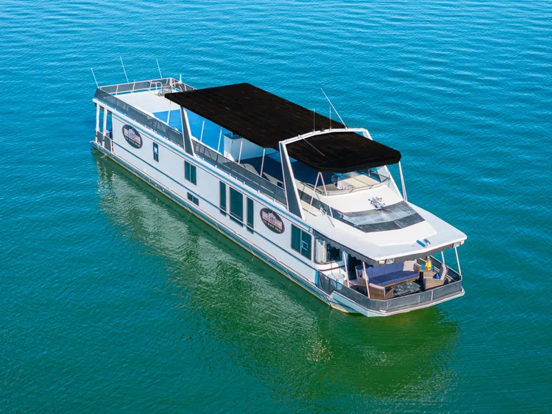 Slide: The Image of 1998 Stardust Cruisers Custom Luxury Houseboat on serene blue water. - 5