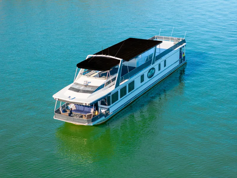 Slide: The Image of 1998 Stardust Cruisers Custom Luxury Houseboat on serene water. - 7