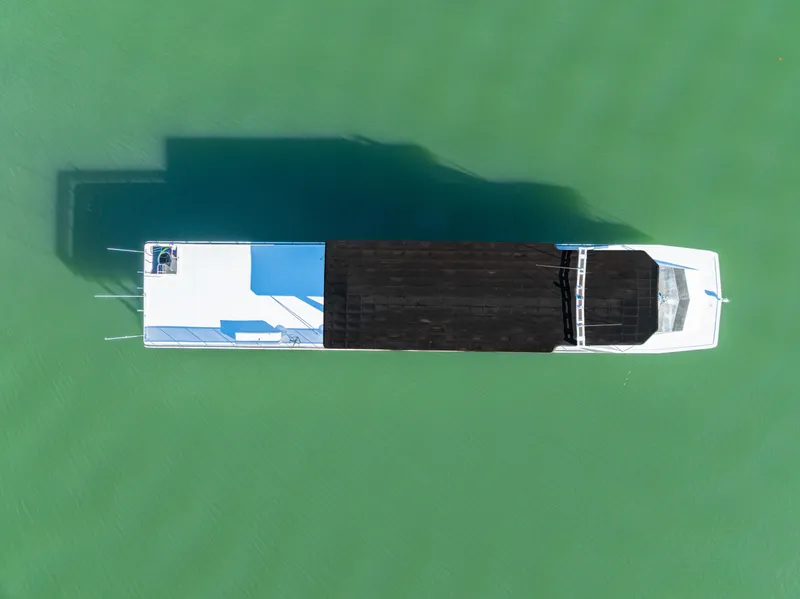 Slide: The Image of Aerial view of 1998 Stardust Cruisers Custom Luxury Houseboat on green water. - 9