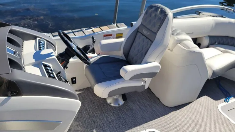 Slide: The Image of 2020 Bennington 24 RTFBC boat interior with plush captain's chair and sleek dashboard. - 5