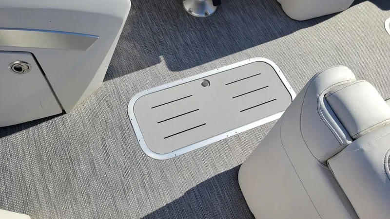 Slide: The Image of Bennington 24 RTFBC 2020 boat interior with gray carpet and storage compartment. - 8