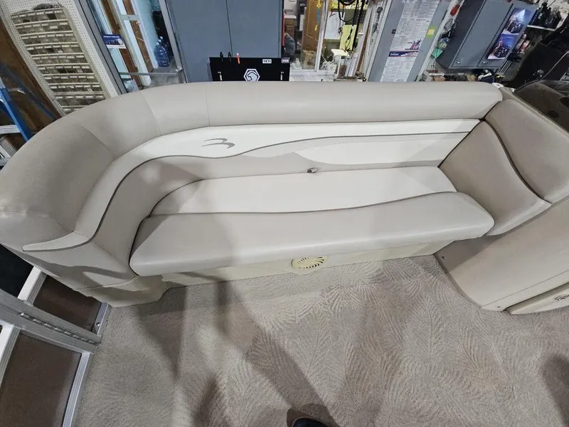 Slide: The Image of 2012 Bennington 20SL boat seating, beige upholstery, indoor showroom display. - 11