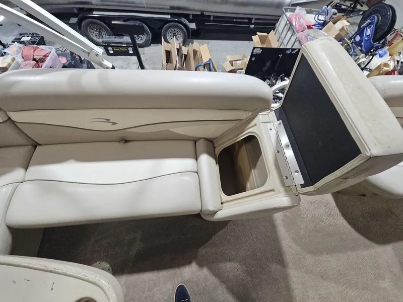 Slide: The Image of 2012 Bennington 20SL boat seat with storage compartment, beige upholstery, indoor setting. - 14