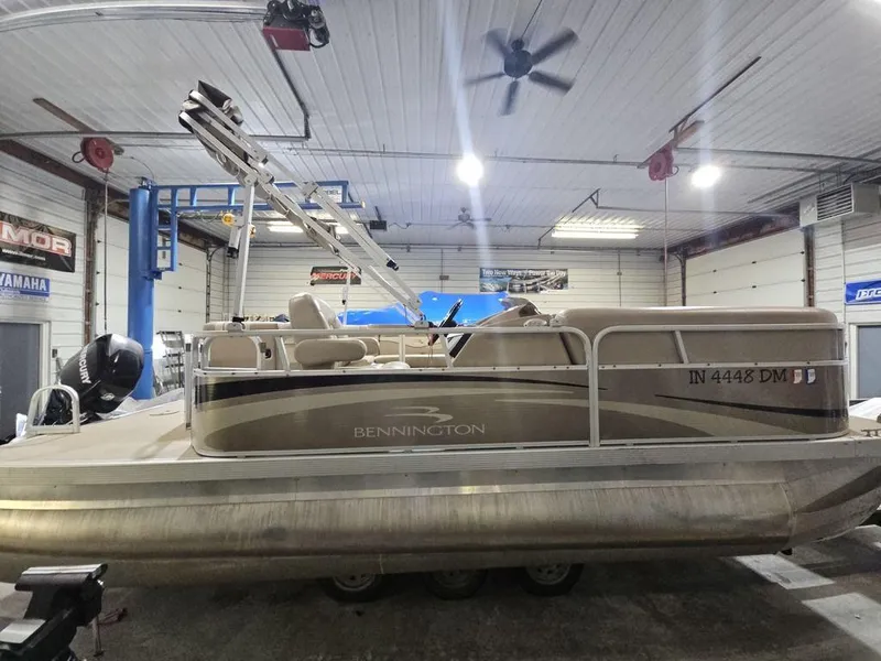 Slide: The Image of 2012 Bennington 20SL pontoon boat in a garage setting. - 15