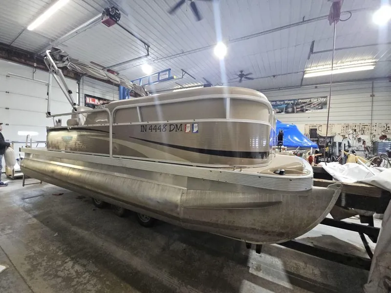 Slide: The Image of 2012 Bennington 20SL pontoon boat in a garage setting. - 16