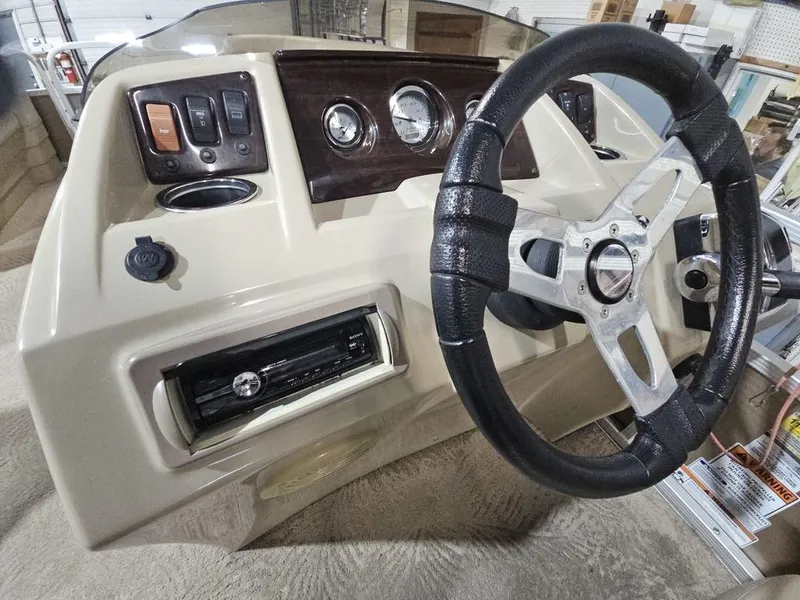 Slide: The Image of 2012 Bennington 20SL boat dashboard with steering wheel and control panel. - 3