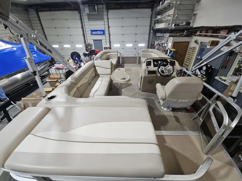 Slide: The Image of 2012 Bennington 20SL pontoon boat interior with beige seating and steering console. - 4
