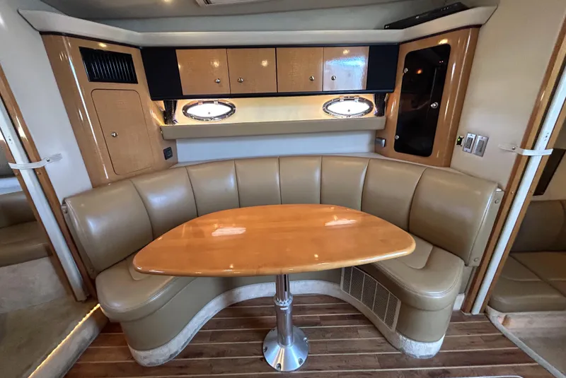 Slide: The Image of 2006 Chaparral Signature 350 interior with curved seating and wooden table. - 10