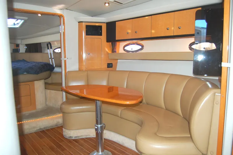 Slide: The Image of 2006 Chaparral Signature 350 interior with leather seating and wooden table. - 12