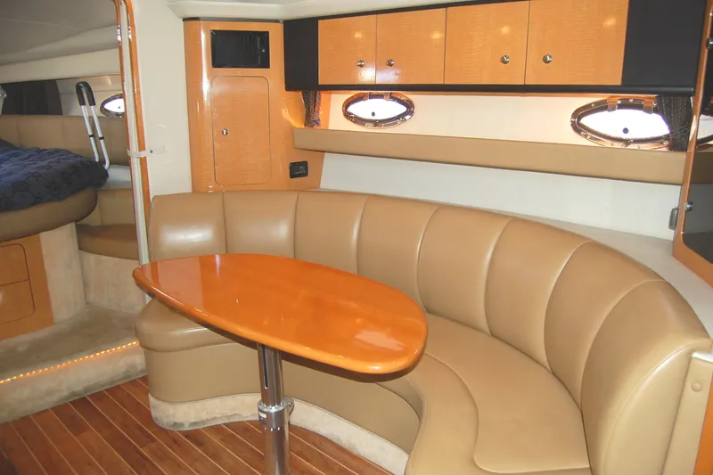Slide: The Image of 2006 Chaparral Signature 350 interior with curved seating and wooden table. - 14