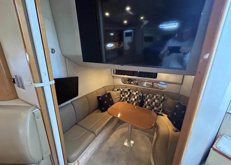 Slide: The Image of Interior of 2006 Chaparral Signature 350 yacht with cozy seating and wooden table. - 18