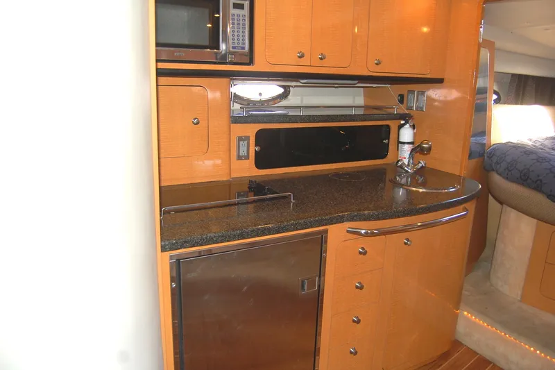 Slide: The Image of 2006 Chaparral Signature 350 yacht kitchen with wood cabinets and modern appliances. - 24