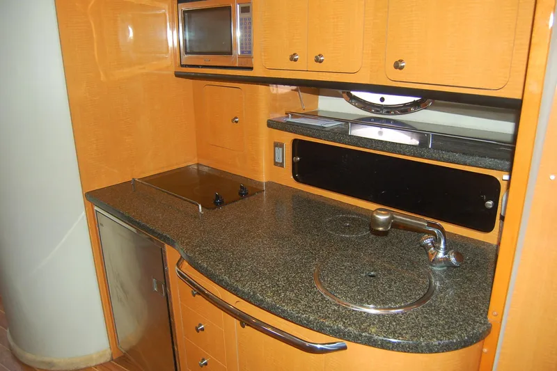Slide: The Image of 2006 Chaparral Signature 350 yacht kitchen with granite countertop, microwave, and sink. - 25