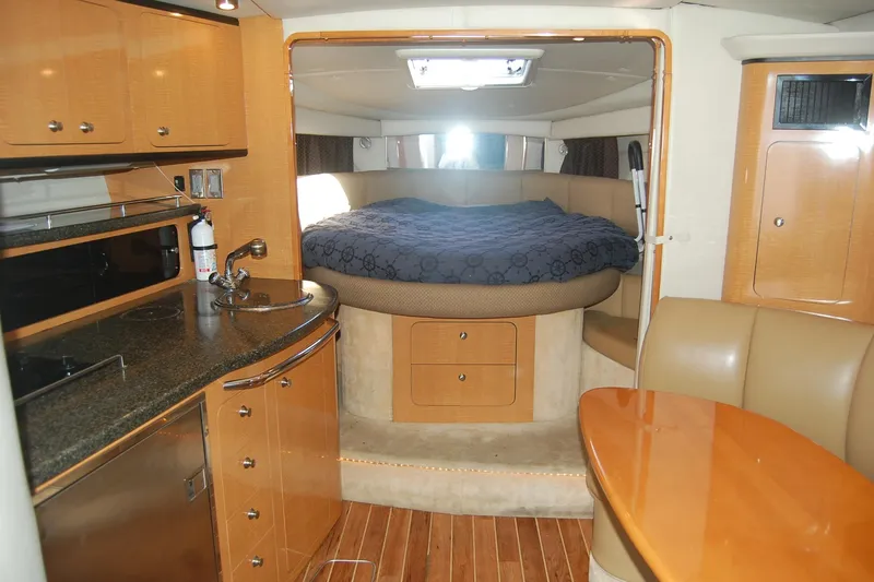 Slide: The Image of 2006 Chaparral Signature 350 interior with kitchen, bed, and dining area. - 27